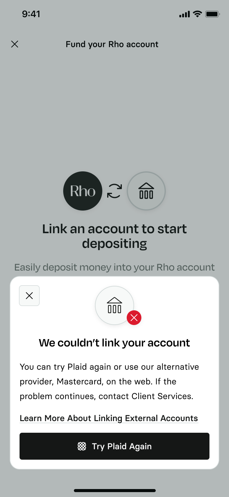A mobile banking error screen with a dimmed background showing a notification modal overlay. The card features a bank icon with a red error cross badge alongside the text We couldn’t link your account, advising the user to try Plaid again or use Mastercard on the web, and features a prominent black button at the bottom labeled Try Plaid Again.